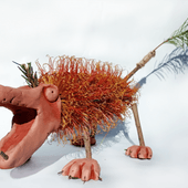 A clay model of a megafauna creature made using a banksia as the body and feathers for the tail