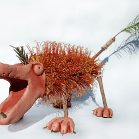 A clay model of a megafauna creature made using a banksia as the body and feathers for the tail